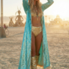 Woman walking in desert wearing a long turquoise sequin hooded duster with white faux fur trim during a festival.