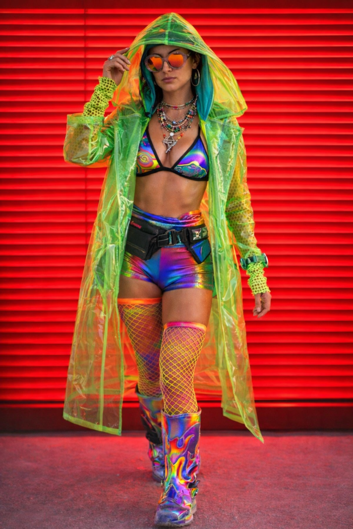a woman wearing a long neon green transparent hooded raincoat