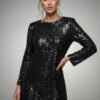 Elegant black long sleeve sequin mini dress featuring a soft jersey lining and crew neck.