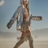 ZEVQ's oversized silver sequin hooded jacket worn at a festival, creating a liquid-metal sparkle effect.