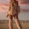 Blush pink faux feather leg warmers with shimmering sequin trim, styled over combat boots for a festival look.