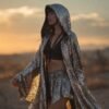 Model wearing the premium silver sequin hooded kaftan and matching shorts festival set at a rave.