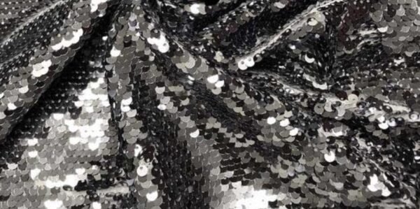 Model wearing the premium silver sequin hooded kaftan and matching shorts festival set at a rave.