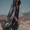 ZEVQ Silver Sequin Hooded Duster custom print maxi coat creating a liquid metal effect at a festival