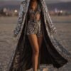 Model wearing the premium silver sequin hooded kaftan and matching shorts festival set at a rave.