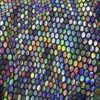 ZEVQ's custom holographic sequin duster, a shimmering festival kimono, worn at a vibrant event.