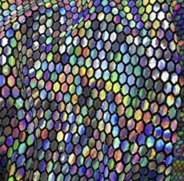 ZEVQ's custom holographic sequin duster, a shimmering festival kimono, worn at a vibrant event.