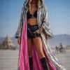 ZEVQ's custom holographic sequin duster, a shimmering festival kimono, worn at a vibrant event.