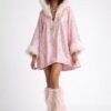 Blush pink faux feather leg warmers with shimmering sequin trim, styled over combat boots for a festival look.