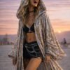 ZEVQ's custom holographic sequin duster, a shimmering festival kimono, worn at a vibrant event.