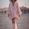 Blush pink faux feather leg warmers with shimmering sequin trim, styled over combat boots for a festival look.