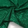ZEVQ Emerald Green Sequin Hooded Duster Coat flowing in the desert wind at a festival