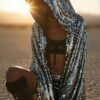 Model wearing the premium silver sequin hooded kaftan and matching shorts festival set at a rave.
