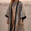 ZEVQ Silver Mirror Tile Kimono Duster, a metallic festival robe with satin trim, worn at a desert rave.