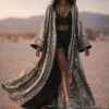 Custom Metallic Mirror Duster Coat in silver with black silk satin lining, worn at a festival
