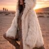 ZEVQ premium faux fur hooded festival duster coat with emerald satin lining, worn at a festival.
