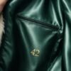 ZEVQ premium faux fur hooded festival duster coat with emerald satin lining, worn at a festival.
