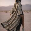 Custom Metallic Mirror Duster Coat in silver with black silk satin lining, worn at a festival