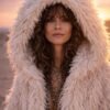 ZEVQ premium faux fur hooded festival duster coat with emerald satin lining, worn at a festival.