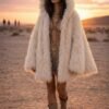 ZEVQ premium faux fur hooded festival duster coat with emerald satin lining, worn at a festival.