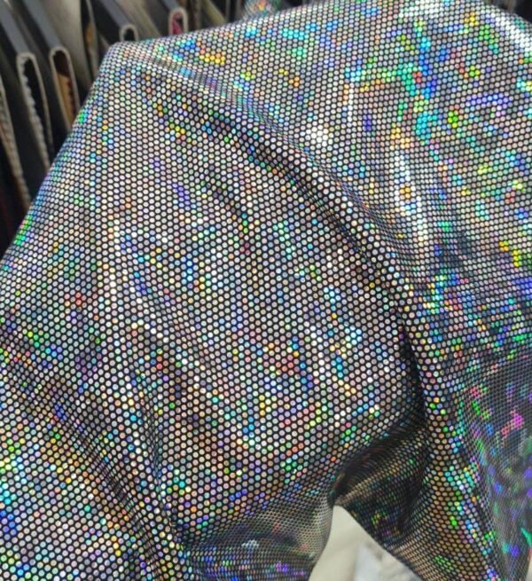 Model wearing a custom holographic silver festival duster kimono at a festival, showcasing its reflective, light-shifting properties.