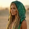 ZEVQ Emerald Green Sequin Hooded Maxi Vest, a premium festival duster worn at a desert rave.
