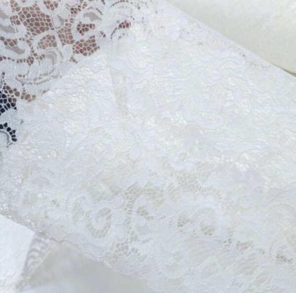 White lace hooded maxi vest, a boho festival duster with gold trim, worn at a festival.