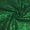 ZEVQ premium emerald sequin festival cloak with dramatic white faux fur trim, worn at a festival.