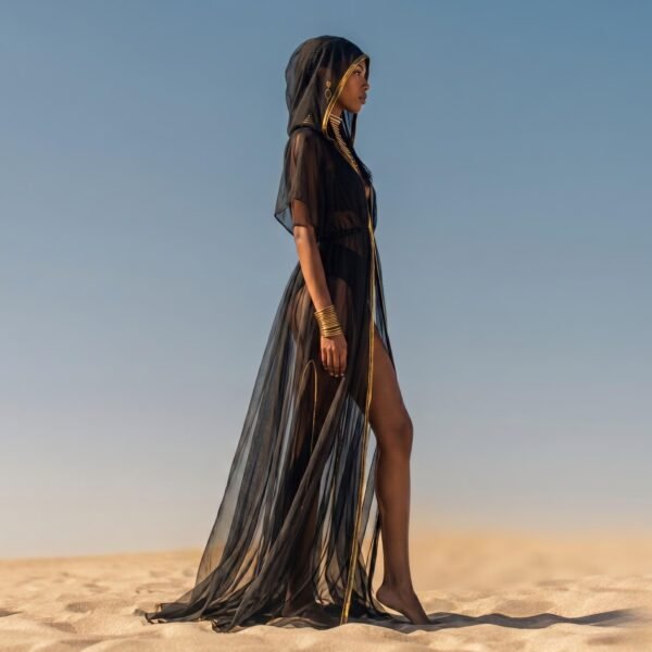 ZEVQ Black Sheer Hooded Chiffon Festival Kaftan with Gold Trim, worn at a desert festival.