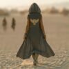 ZEVQ Owl Oracle Black Linen Hooded Duster worn at a festival, showcasing the shamanic back print and flowing silhouette.