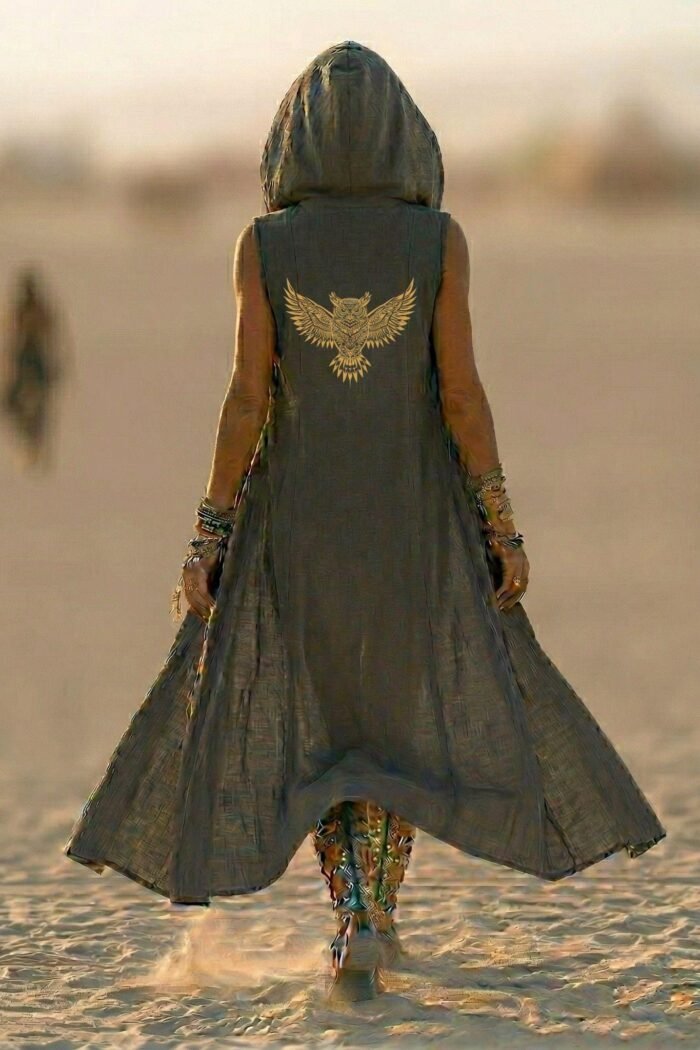 ZEVQ Owl Oracle Black Linen Hooded Duster worn at a festival, showcasing the shamanic back print and flowing silhouette.