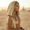 Model wearing the premium Gold Sequin Hooded Maxi Vest, a festival statement duster, at sunset.