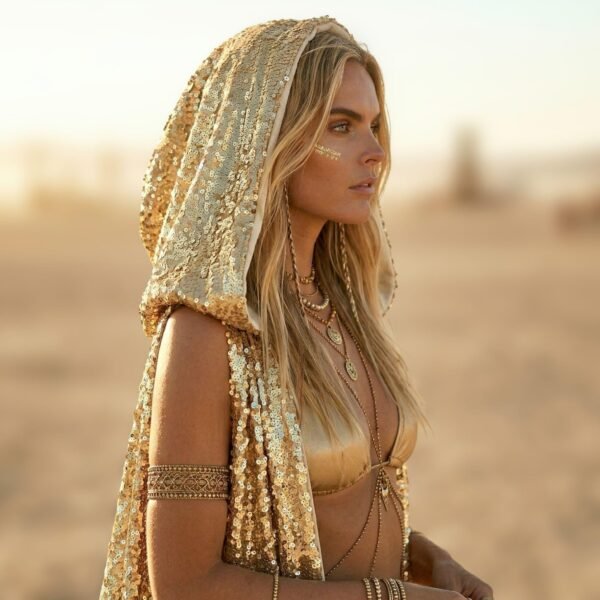 Model wearing the premium Gold Sequin Hooded Maxi Vest, a festival statement duster, at sunset.