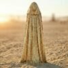 Model wearing the premium Gold Sequin Hooded Maxi Vest, a festival statement duster, at sunset.