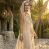 White lace hooded maxi vest, a boho festival duster with gold trim, worn at a festival.