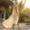 White lace hooded maxi vest, a boho festival duster with gold trim, worn at a festival.