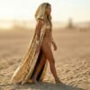 Model wearing the premium Gold Sequin Hooded Maxi Vest, a festival statement duster, at sunset.