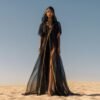 ZEVQ Black Sheer Hooded Chiffon Festival Kaftan with Gold Trim, worn at a desert festival.